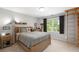 Comfortable bedroom with natural light, light colored walls, and wooden bed frame at 44 Kingsford Xing, Acworth, GA 30101