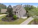 Side view of the home featuring a long driveway and a basketball court for outdoor activity at 44 Kingsford Xing, Acworth, GA 30101
