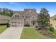 Beautiful two-story home with a well-manicured lawn, mature trees, and a three-car garage at 44 Kingsford Xing, Acworth, GA 30101