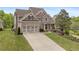 Charming two-story home features a two-car garage, lush lawn, and manicured landscaping at 44 Kingsford Xing, Acworth, GA 30101