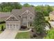 Charming two-story home with a two-car garage and beautifully landscaped front yard at 44 Kingsford Xing, Acworth, GA 30101