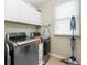 Efficient laundry room equipped with modern washer, dryer, and ample storage cabinets at 44 Kingsford Xing, Acworth, GA 30101