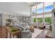 Bright living room featuring soaring windows, fireplace, hardwood floors and open access to the kitchen and breakfast nook at 44 Kingsford Xing, Acworth, GA 30101