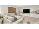 Relaxing living room with sectional sofa, entertainment center, and barn doors at 44 Kingsford Xing, Acworth, GA 30101