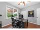 Home office with a sleek black desk, hardwood floors, and a window providing natural light at 44 Kingsford Xing, Acworth, GA 30101