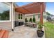 Outdoor patio area featuring a pergola, stone pavers, and dining set with a grill at 44 Kingsford Xing, Acworth, GA 30101
