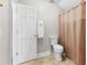 Bathroom featuring a toilet, tile flooring, a towel rack, and a shower with a curtain at 1477 Highway 85 Connector, Brooks, GA 30205