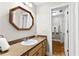 Bathroom features a granite countertop, wood cabinets, mirror and doorway to adjoining area at 1477 Highway 85 Connector, Brooks, GA 30205