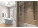 Bathroom with a freestanding tub, a glass-enclosed shower, and tile flooring at 1477 Highway 85 Connector, Brooks, GA 30205