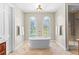 Bathroom featuring a freestanding tub, arched windows, and gold hardware at 1477 Highway 85 Connector, Brooks, GA 30205