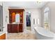 Elegant bathroom featuring a soaking tub, custom wood vanity, and walk-in closet at 1477 Highway 85 Connector, Brooks, GA 30205