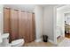 Bathroom with toilet, shower with curtain, and vanity visible through doorway at 1477 Highway 85 Connector, Brooks, GA 30205