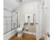 Bathroom featuring shower and tub with glass doors, toilet, towel rack, and wood-look flooring at 1477 Highway 85 Connector, Brooks, GA 30205