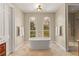 Luxurious bathroom featuring a standalone tub, elegant fixtures, and a glass-enclosed shower at 1477 Highway 85 Connector, Brooks, GA 30205