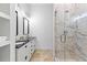 Modern bathroom featuring double sinks, dark countertops, marble shower, and bright lighting at 1477 Highway 85 Connector, Brooks, GA 30205