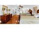 Spacious bedroom with two beds, a ceiling fan, a dresser, and hardwood floors throughout at 1477 Highway 85 Connector, Brooks, GA 30205