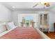 Well lit bedroom with hardwood floors, a sitting area, and a ceiling fan at 1477 Highway 85 Connector, Brooks, GA 30205