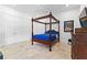 Bedroom featuring a four-poster bed, double closets, and travertine flooring at 1477 Highway 85 Connector, Brooks, GA 30205