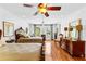 Spacious bedroom with hardwood floors, two beds, a ceiling fan, and natural light at 1477 Highway 85 Connector, Brooks, GA 30205