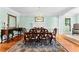 Formal dining room with a decorative rug, hardwood floors, and stylish furniture at 1477 Highway 85 Connector, Brooks, GA 30205
