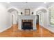 Elegant fireplace in living room with hardwood floors and arched doorways at 1477 Highway 85 Connector, Brooks, GA 30205