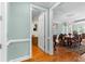 Hallway view of dining room with hardwood floors, fireplace and chandelier at 1477 Highway 85 Connector, Brooks, GA 30205