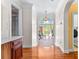 Bright hallway with hardwood floors, arched doorway with transom window, and access to other rooms at 1477 Highway 85 Connector, Brooks, GA 30205