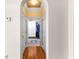 Hallway with a view into the walk-in closet, featuring hardwood floors and an archway at 1477 Highway 85 Connector, Brooks, GA 30205