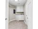 Laundry room featuring white cabinets, a sink, tile floors, and wire shelving for storage at 1477 Highway 85 Connector, Brooks, GA 30205