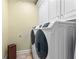 Laundry room showcasing modern, front-load washer and dryer sets, with bright lighting and cabinets at 1477 Highway 85 Connector, Brooks, GA 30205