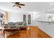 Bright living room with hardwood floors, neutral paint, ceiling fan, sofa, and french doors to the outside at 1477 Highway 85 Connector, Brooks, GA 30205
