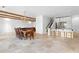 Open-concept living space with travertine floors, wooden beams, dining area, and modern kitchen at 1477 Highway 85 Connector, Brooks, GA 30205