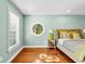 Bright main bedroom with a unique round window and hardwood floors, offering ample natural light at 1477 Highway 85 Connector, Brooks, GA 30205