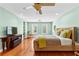 Large main bedroom with hardwood floors, light green walls, and ample natural light at 1477 Highway 85 Connector, Brooks, GA 30205