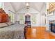 Bright main bedroom with a vaulted ceiling, hardwood floors, and a fireplace at 1477 Highway 85 Connector, Brooks, GA 30205