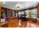 Home office with custom wood bookcases, hardwood flooring, and window views at 1477 Highway 85 Connector, Brooks, GA 30205