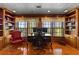 Home office with custom wood bookcases, hardwood flooring, and a large desk at 1477 Highway 85 Connector, Brooks, GA 30205