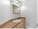 Powder room featuring a granite countertop, a decorative mirror, and wood-look floors at 1477 Highway 85 Connector, Brooks, GA 30205
