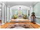 Elegant sitting room featuring columns, light-blue walls and a chandelier at 1477 Highway 85 Connector, Brooks, GA 30205
