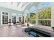 Bright sunroom with spa, tiled floor and large windows offering serene outdoor views at 1477 Highway 85 Connector, Brooks, GA 30205