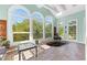 Bright sunroom with spa, tiled floor and large windows offering serene outdoor views at 1477 Highway 85 Connector, Brooks, GA 30205