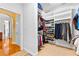 View of a walk-in closet showing shelving and hanging clothes on the storage system at 1477 Highway 85 Connector, Brooks, GA 30205