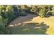 Large fenced-in grassy yard with mature trees and a storage shed for outdoor activities at 1477 Highway 85 Connector, Brooks, GA 30205