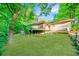Backyard of the home has a spacious lawn and a wooden deck, creating an inviting outdoor living space at 170 Mark Nw Trl, Sandy Springs, GA 30328