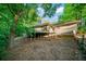 Backyard of the home has a spacious lawn and a wooden deck, creating an inviting outdoor living space at 170 Mark Nw Trl, Sandy Springs, GA 30328