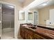Bathroom featuring wood cabinet, marble countertop, and separate glass door shower at 170 Mark Nw Trl, Sandy Springs, GA 30328