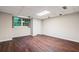 This is a large bedroom with laminate flooring, a window, and a closet at 170 Mark Nw Trl, Sandy Springs, GA 30328