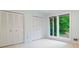 Bright bedroom featuring double closets and windows with a green backyard view at 170 Mark Nw Trl, Sandy Springs, GA 30328