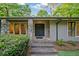 The home's entrance boasts stone pillars, an ornate front door, and stone steps leading up to the entryway at 170 Mark Nw Trl, Sandy Springs, GA 30328