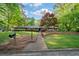 A well-manicured front yard featuring mature landscaping, a charming walkway, and inviting curb appeal at 170 Mark Nw Trl, Sandy Springs, GA 30328